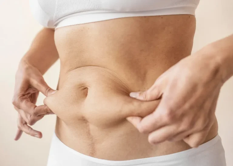 Close up hands holding belly